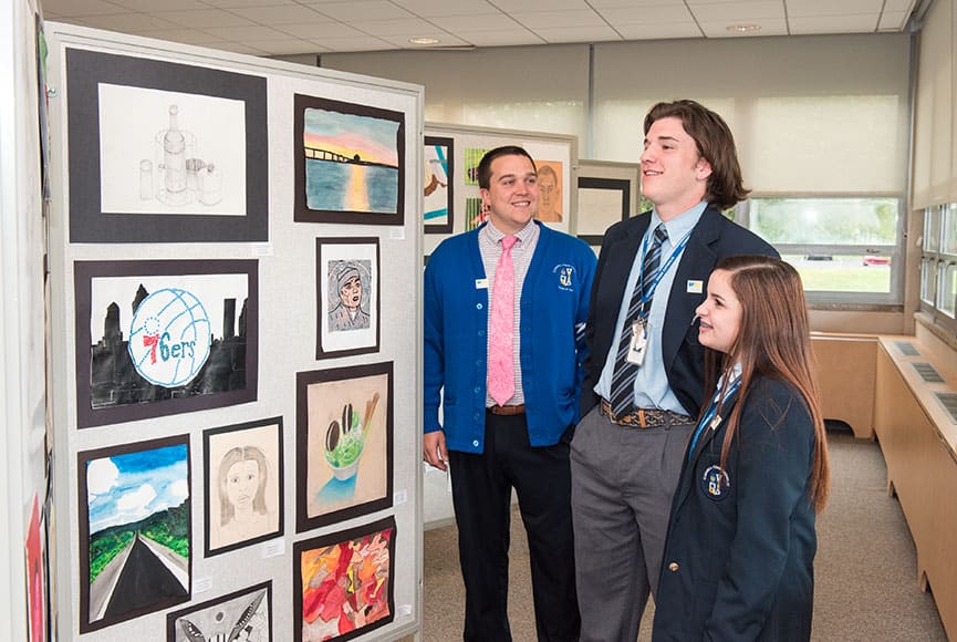 Students looking at class artwork